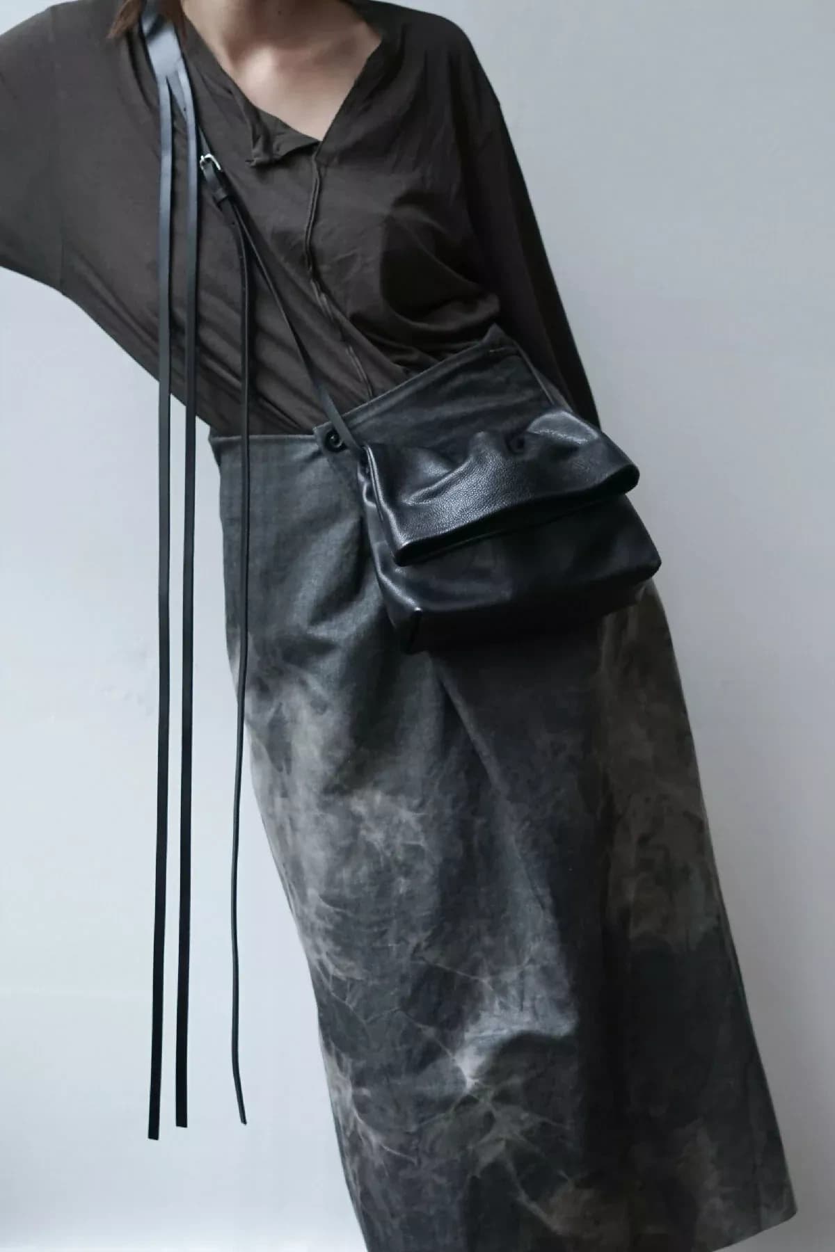 A washed-grey wrap skirt with a long-strapped leather crossbody bag